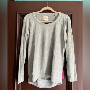 Grey soft Chaser sweater with cool open back!